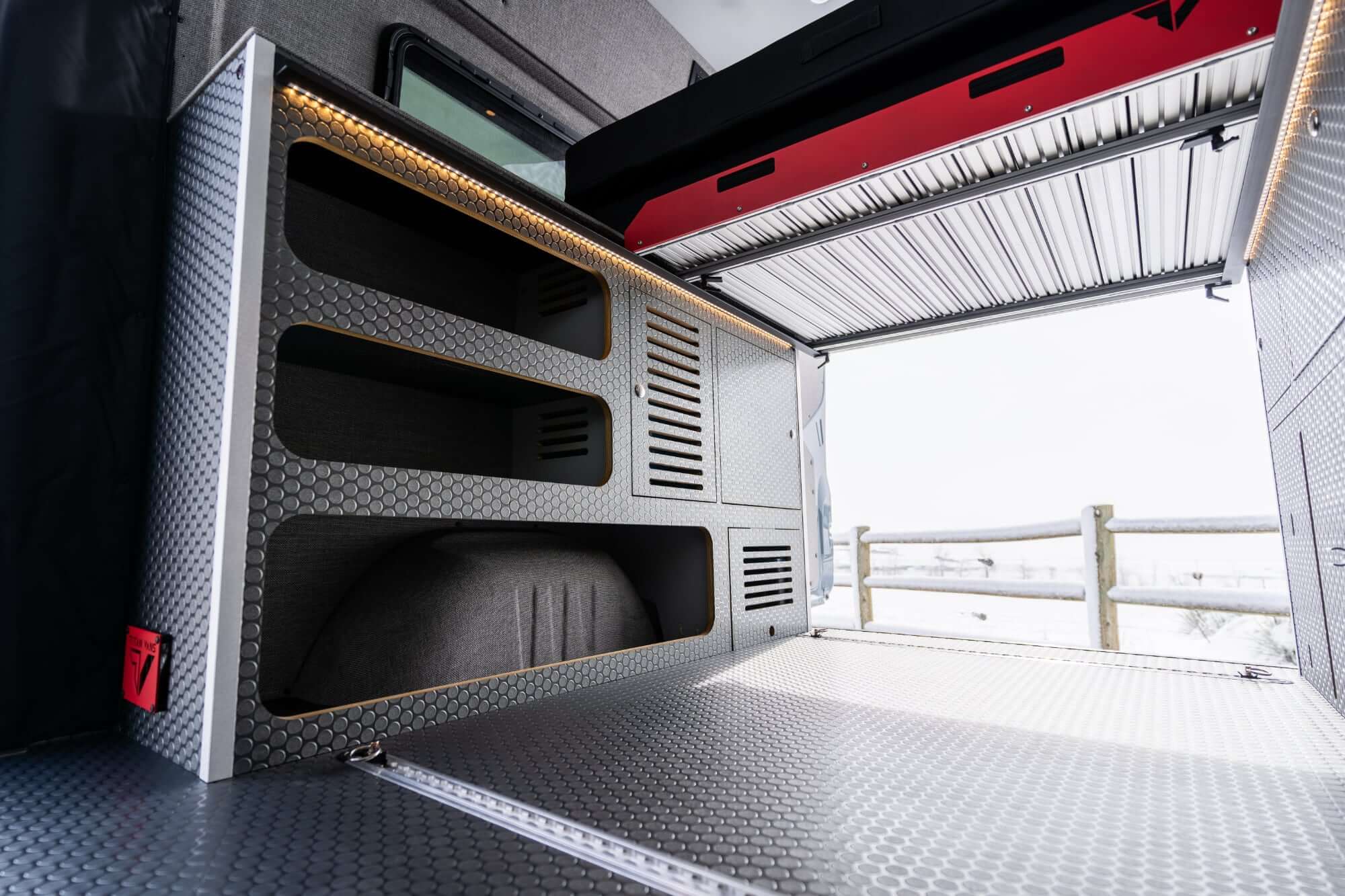 camper van with the rear door open and the retracted sliding-out tray