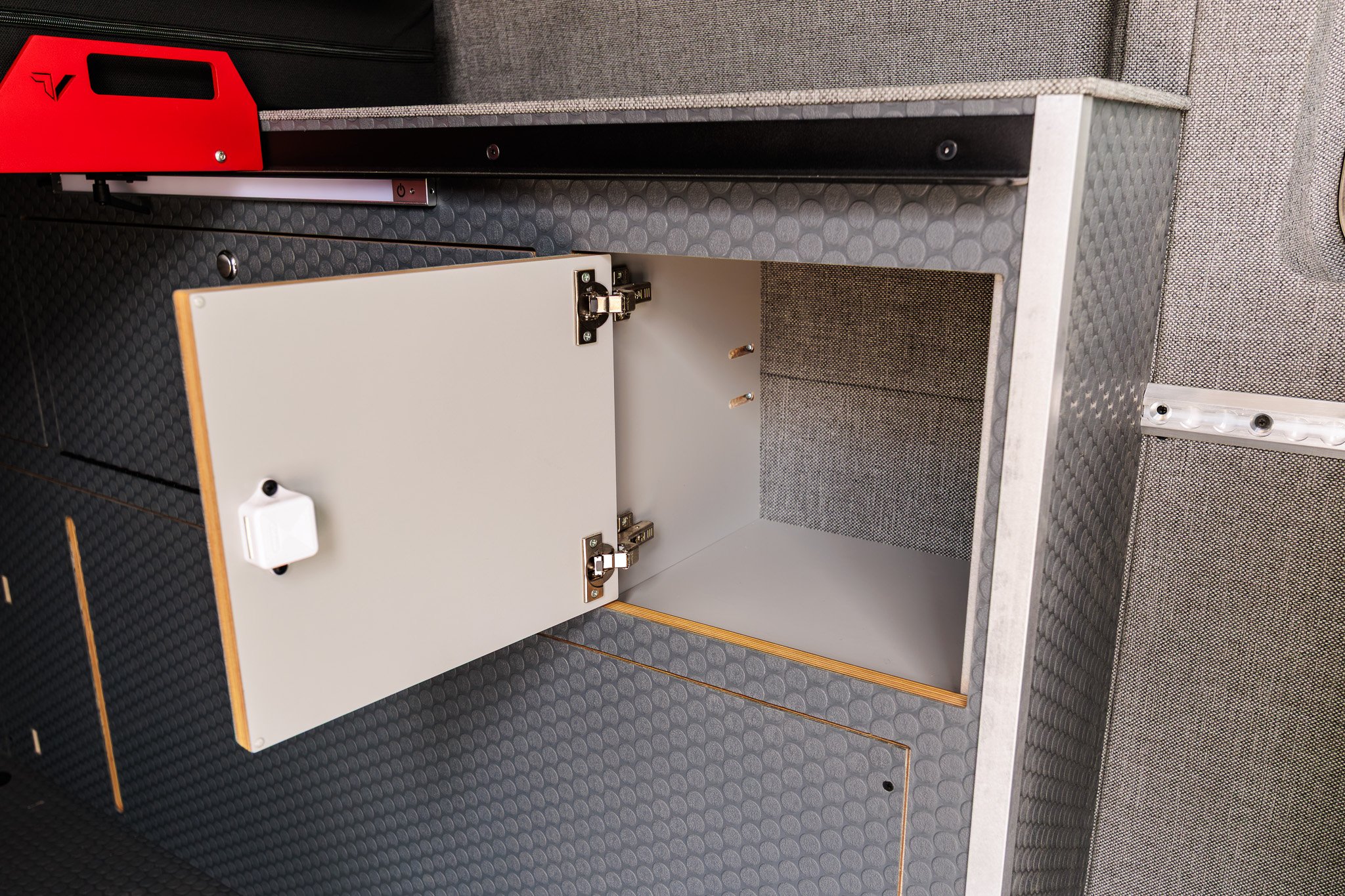 Wheel well cabinet open above the adventure floor