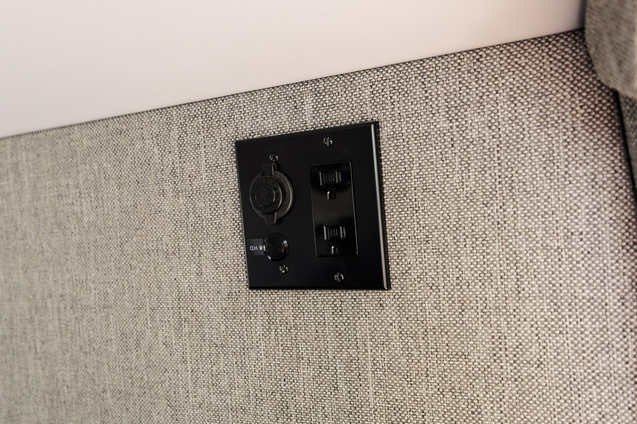 12V, USB and 120V outlet set in the tweed cabin wall