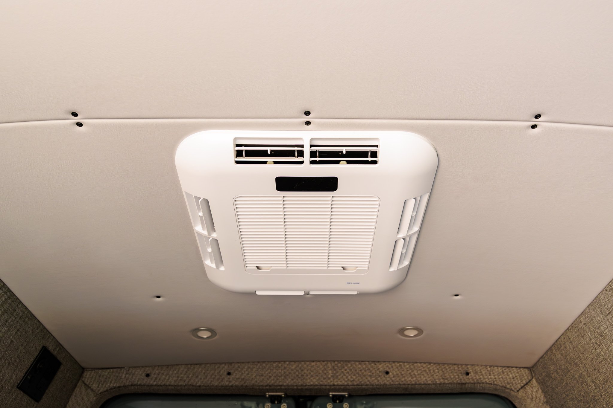 120V rooftop air conditioner in the vinyl ceiling, dimmable overhead lighting around it