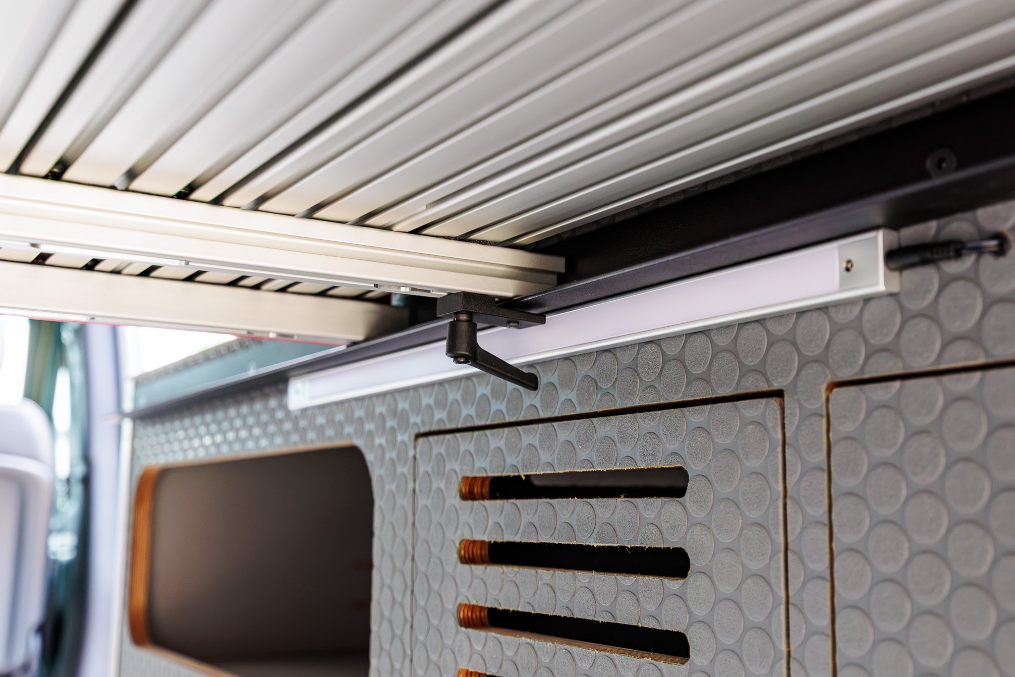Bi-slide aluminum bed rail with the under-bed load light beneath it