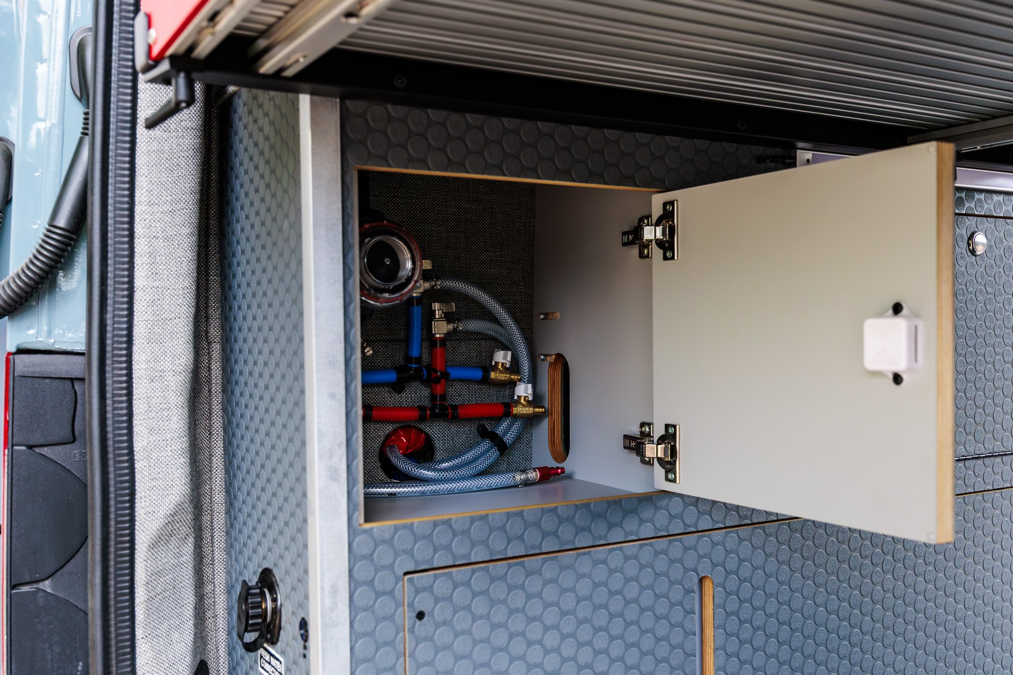 Water bay open on the pump, plumbing manifold and tank heater lines
