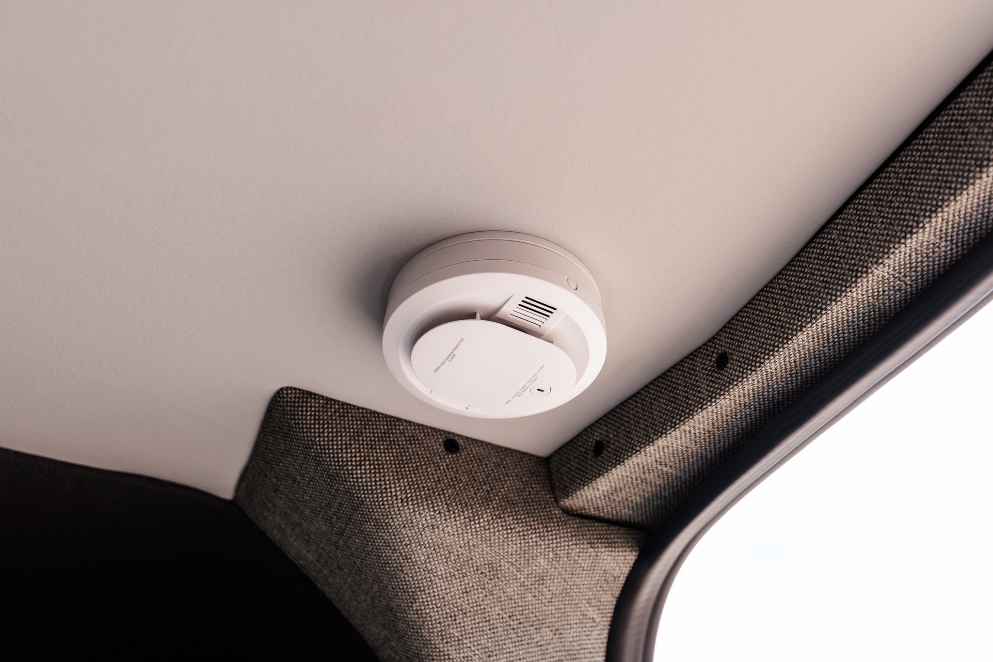 Smoke and carbon monoxide alarm on the vinyl ceiling