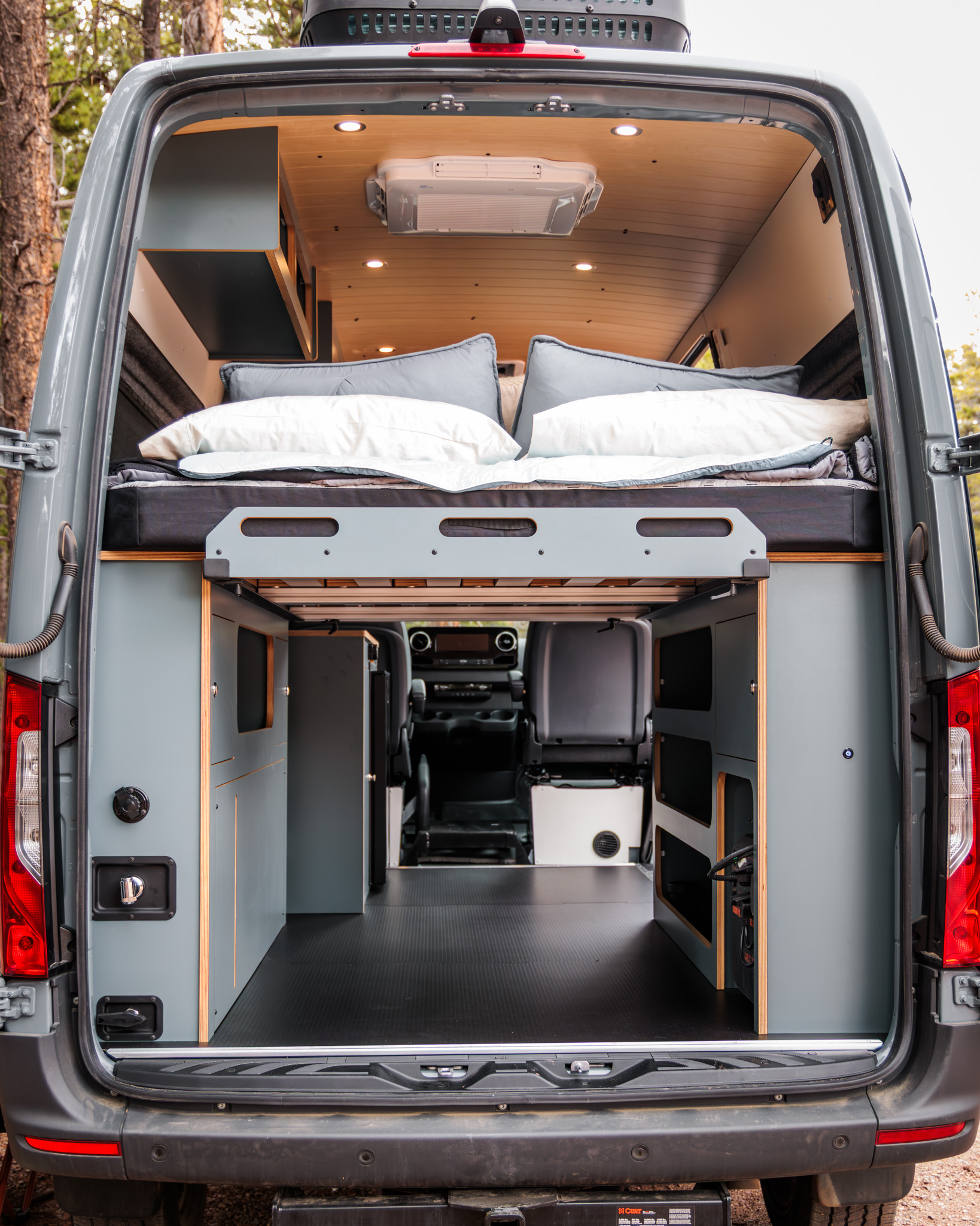Rear doors open on the bed platform and the storage under it