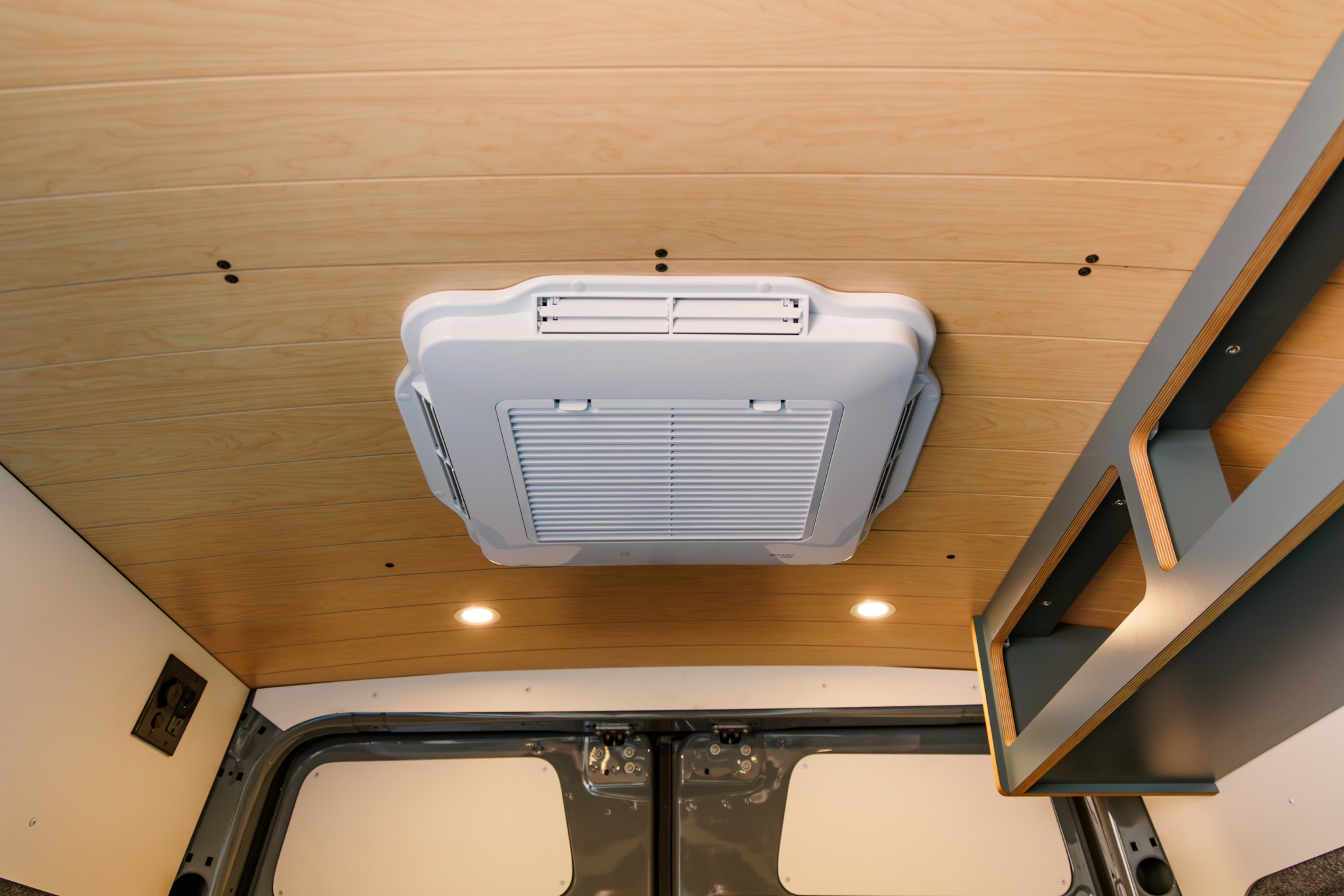 Rooftop air conditioner set into the wood-look ceiling
