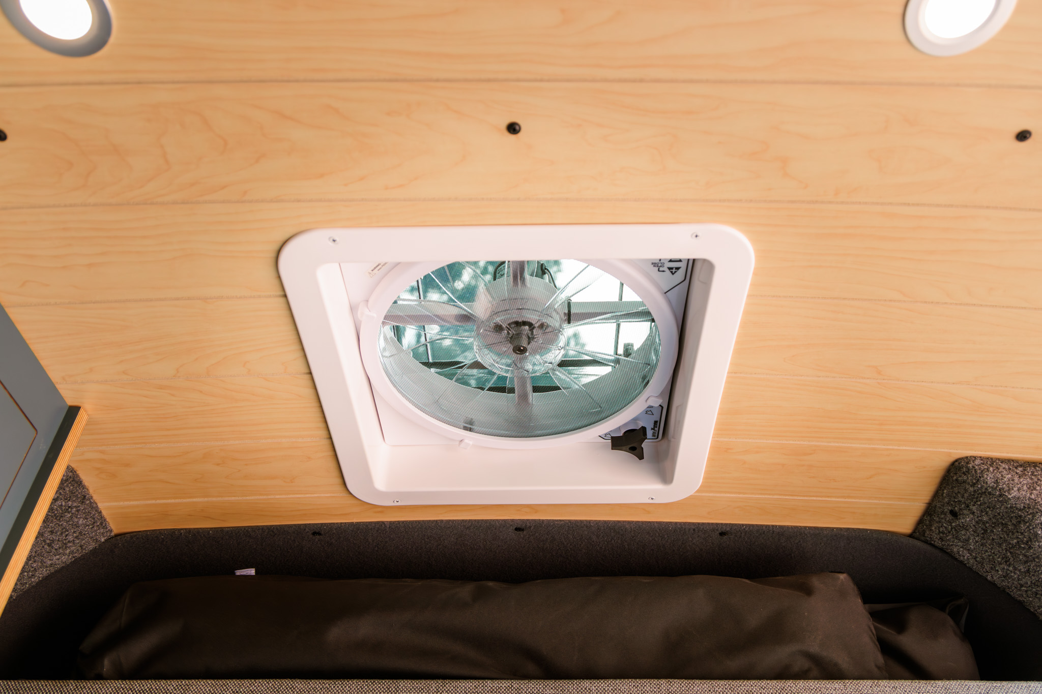 Roof fan in the ceiling above the bed