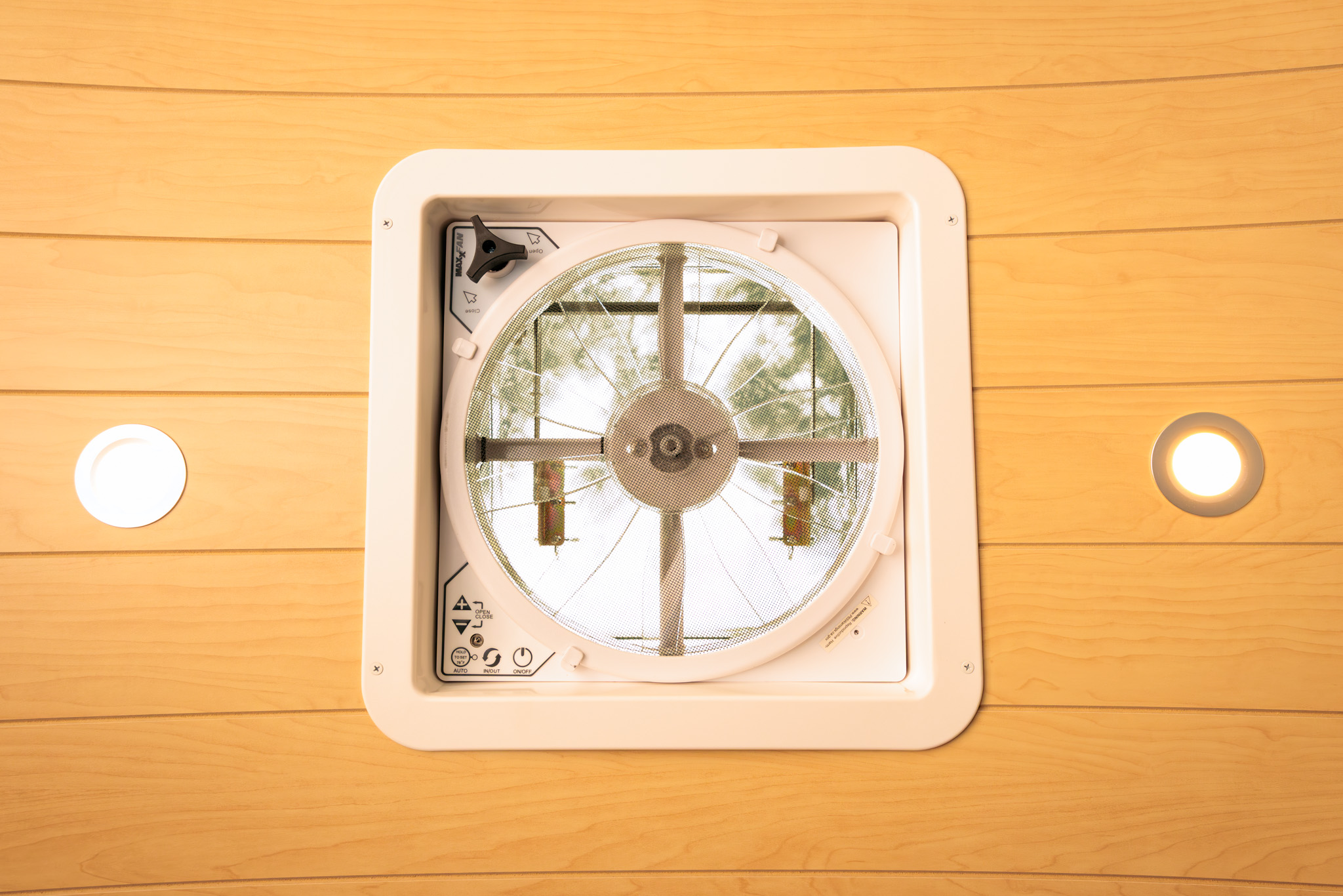 Roof fan set into the ceiling beside the recessed LED lights