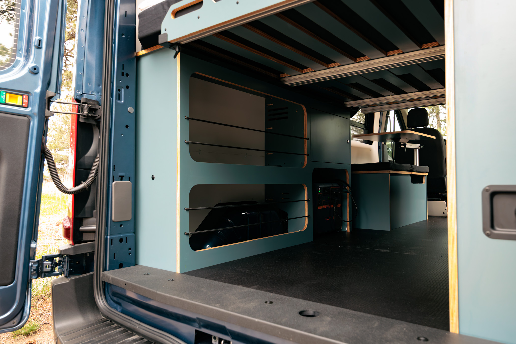 Rear storage area under the bed with the wheel well cabinet