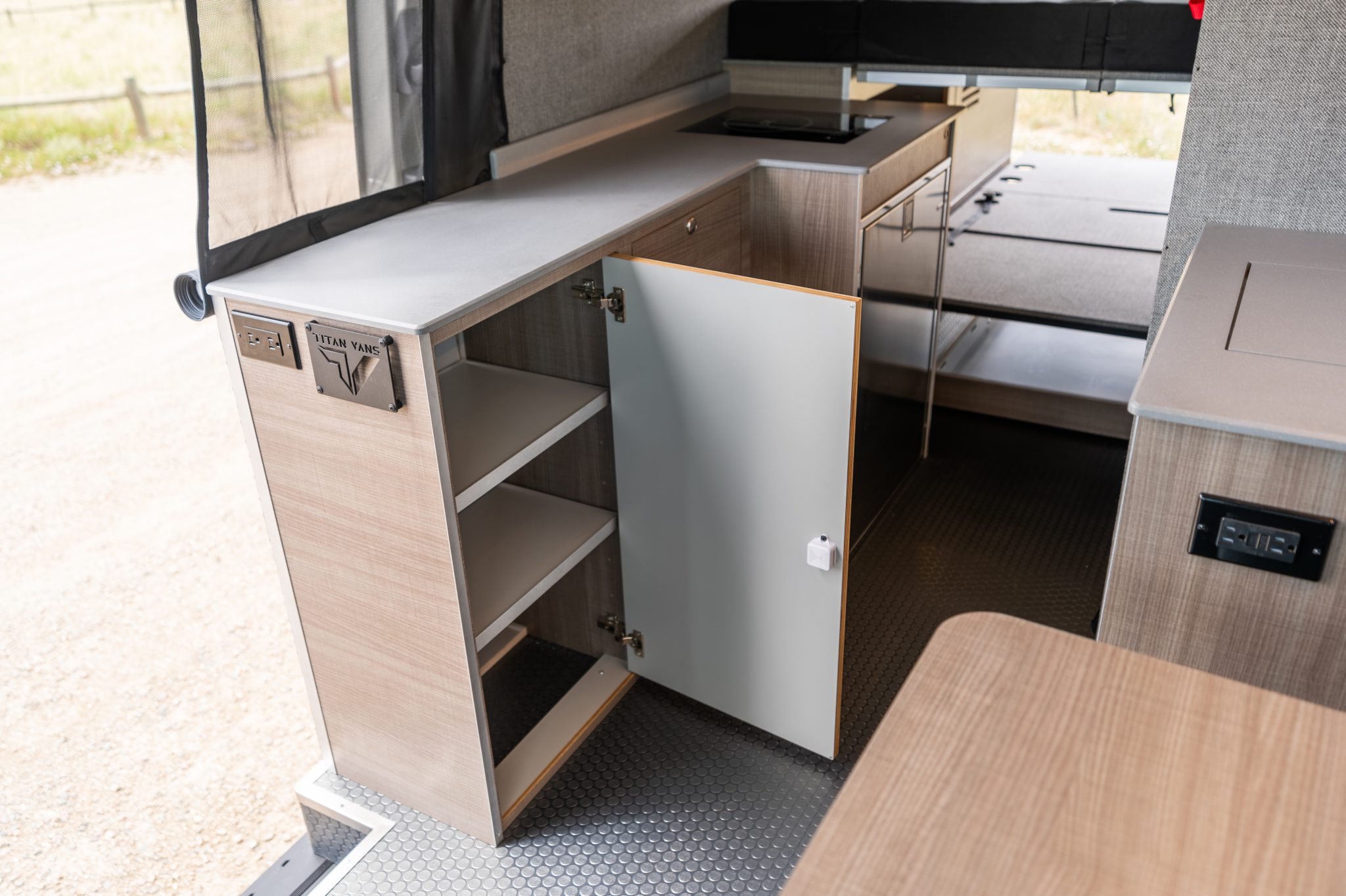 Camper van kitchen galley with the cabinet open