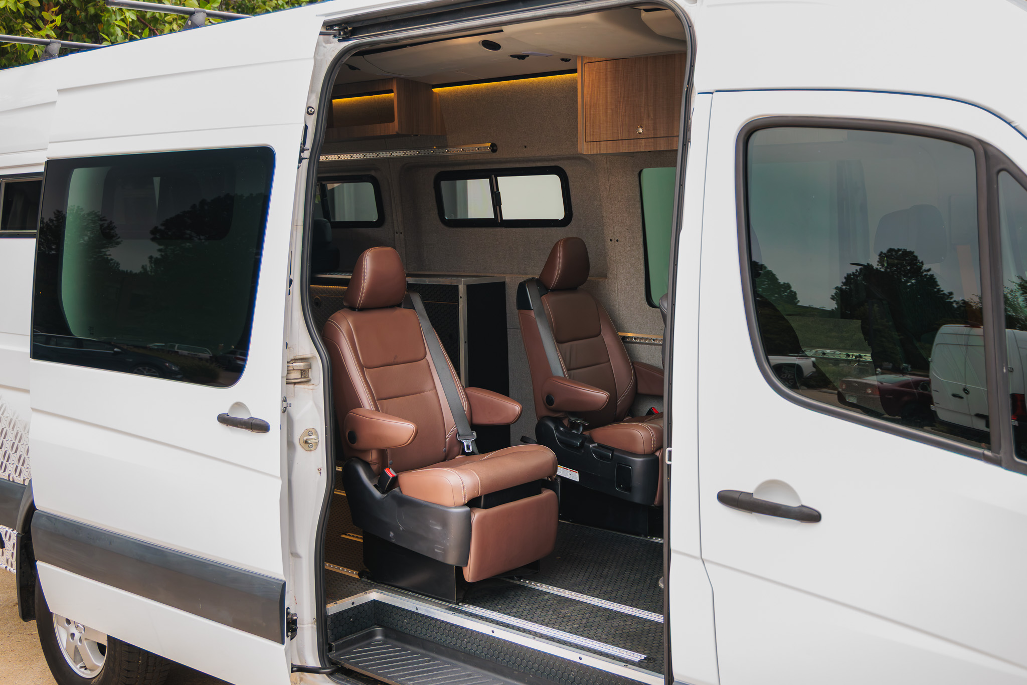 Sliding door open showing the leather captain's chairs