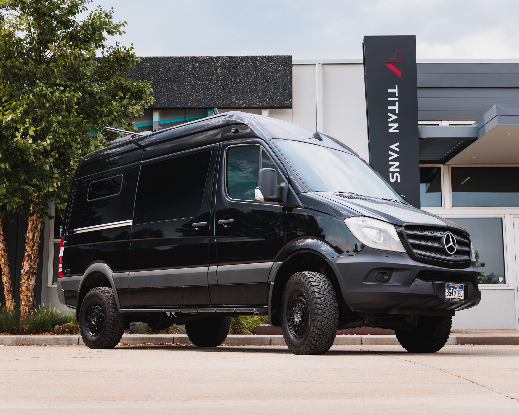 Black Sprinter 144 4x4 camper van exterior, front three quarter