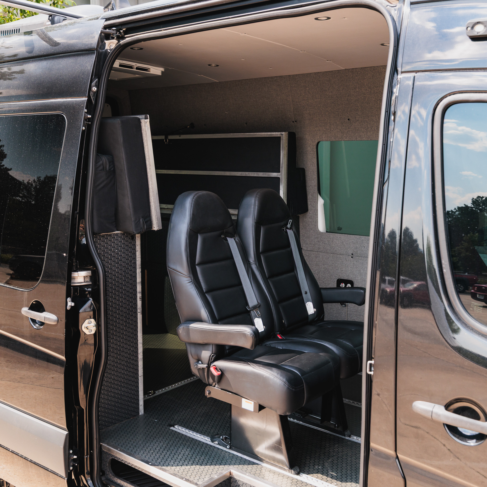Sliding door open showing the swivel seats