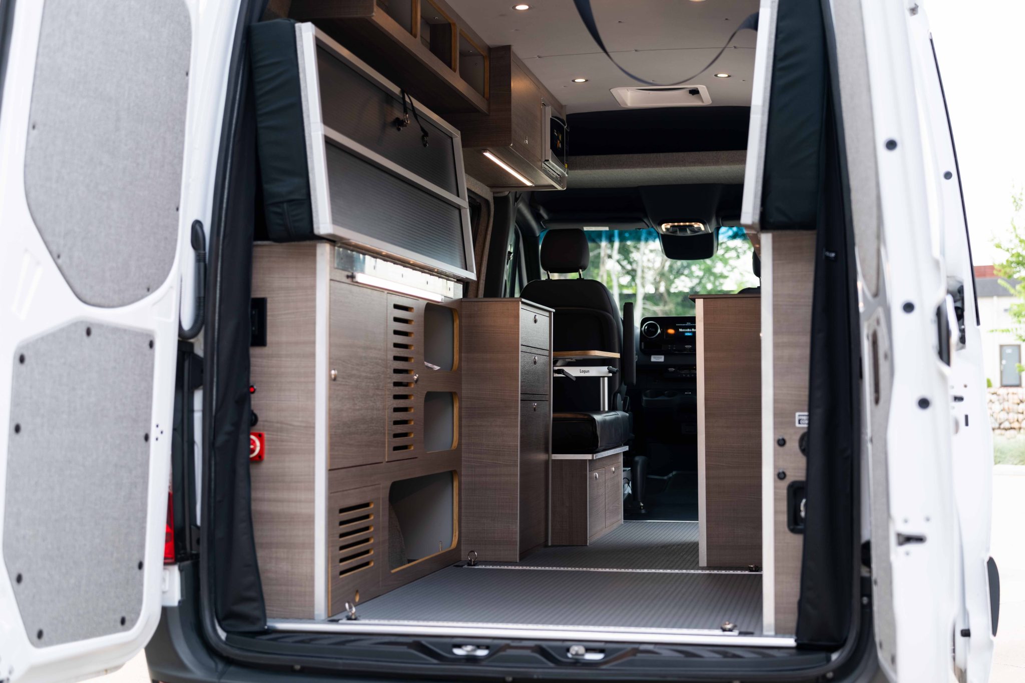 Rear doors open on the Elm laminate cabinetry and the galley