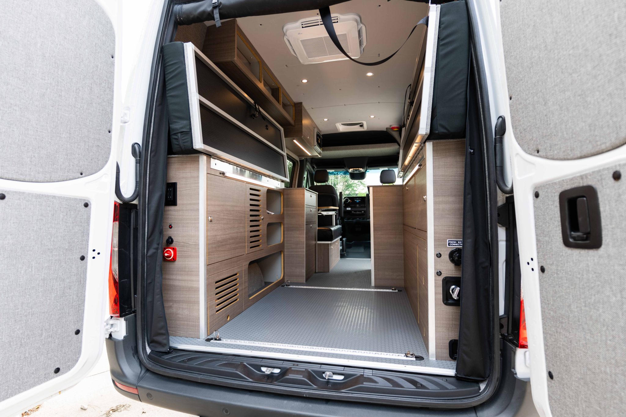 Rear doors open, showing the roof air conditioner and the ceiling