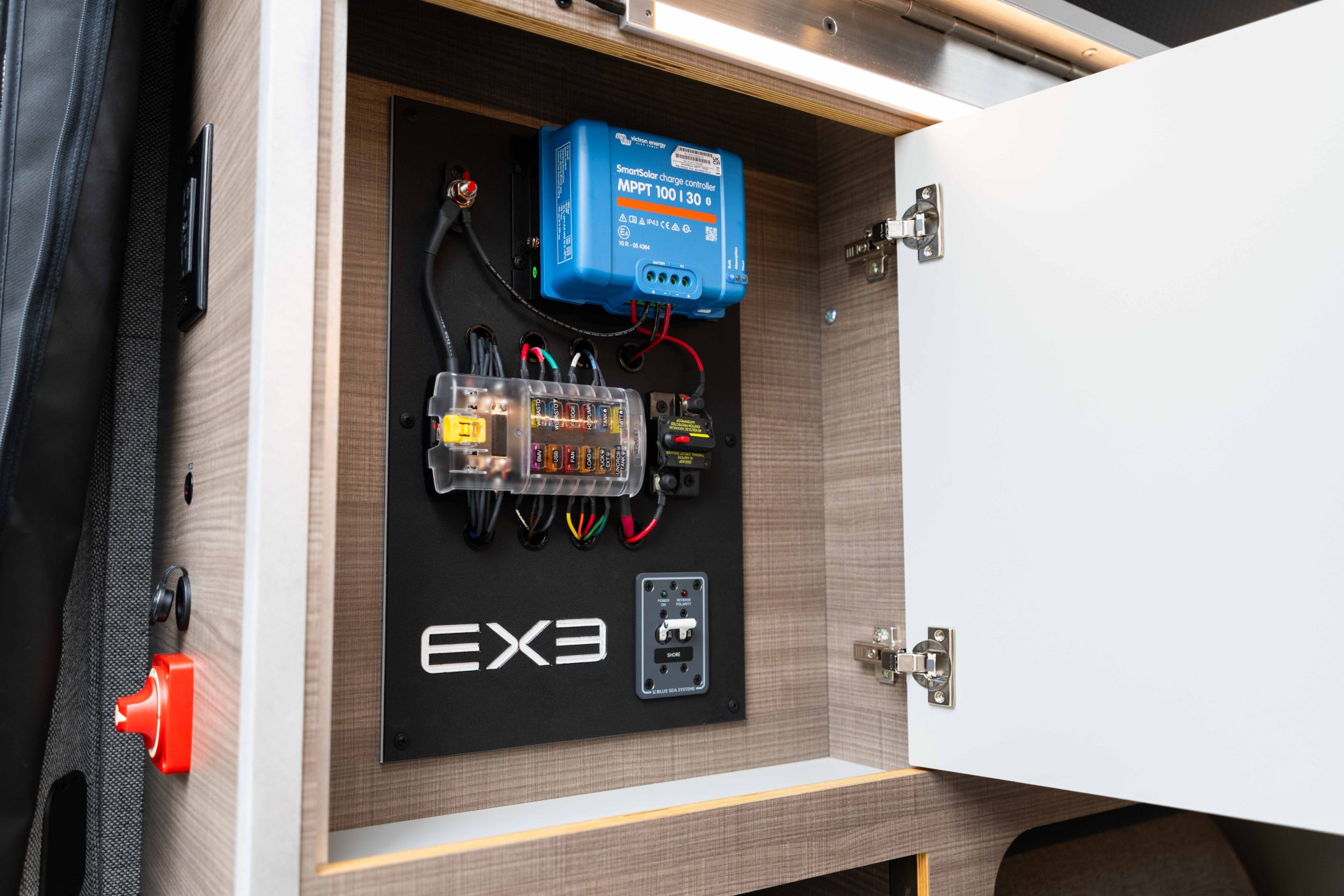 Victron MPPT charge controller, fuse panel and AC outlet in the electrical cabinet