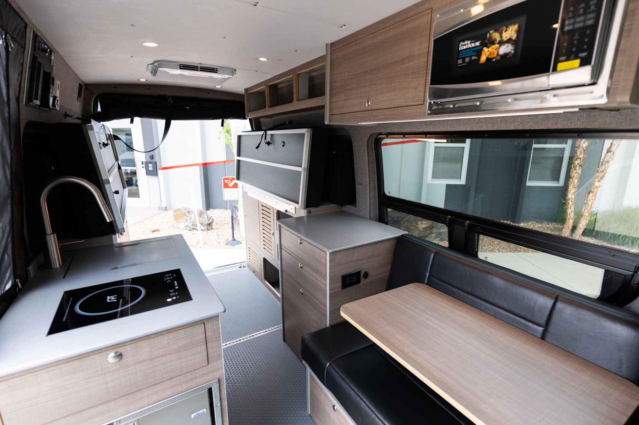 Interior looking rearward: galley, overhead cabinets and the Charcoal dinette