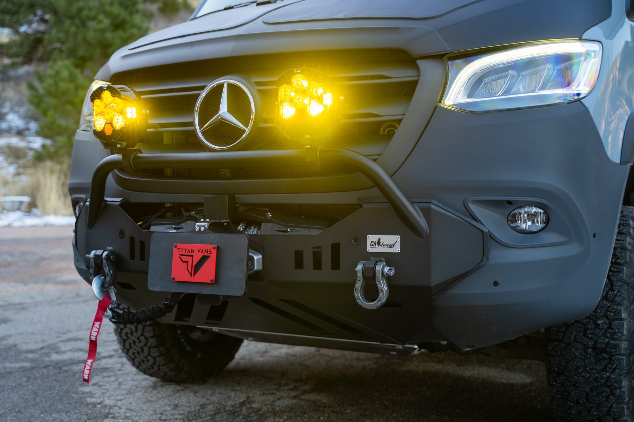 Close-up of the CA-tuned front bumper with the winch, shackles and LP6 lights