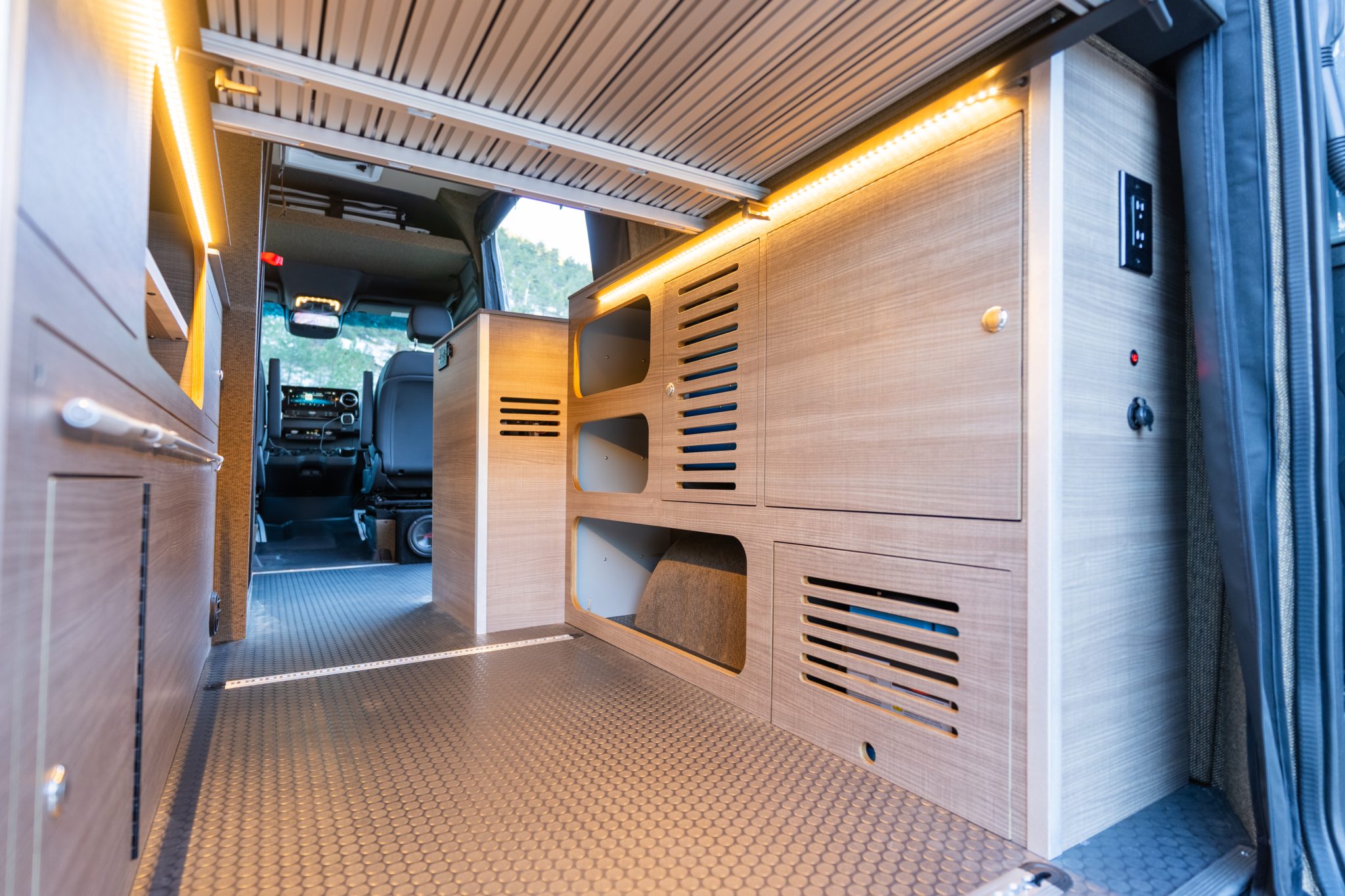 Passenger side cabinetry and storage cubbies, looking forward to the cab