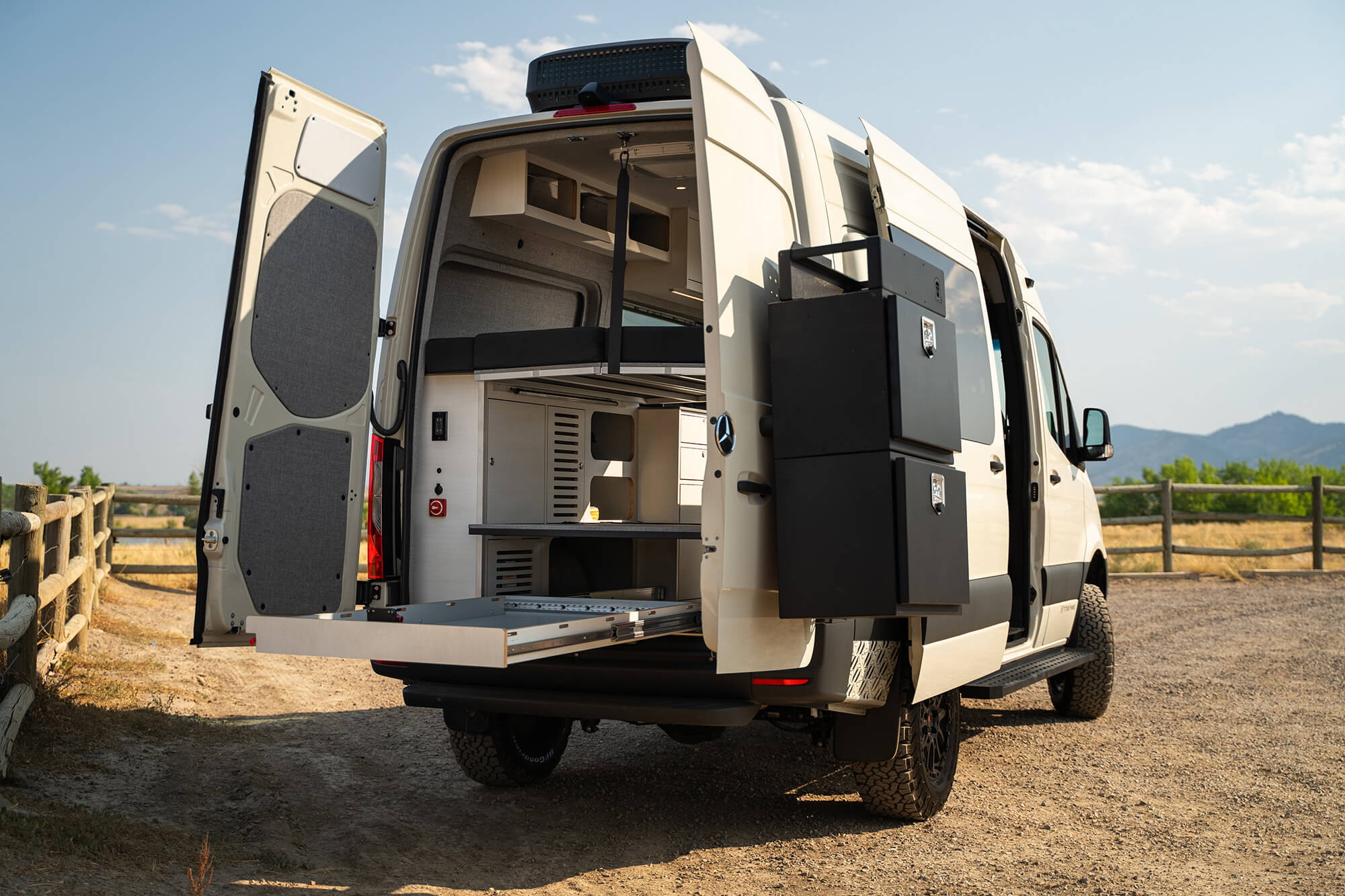 camper van with the rear door open and the retracted sliding-out tray