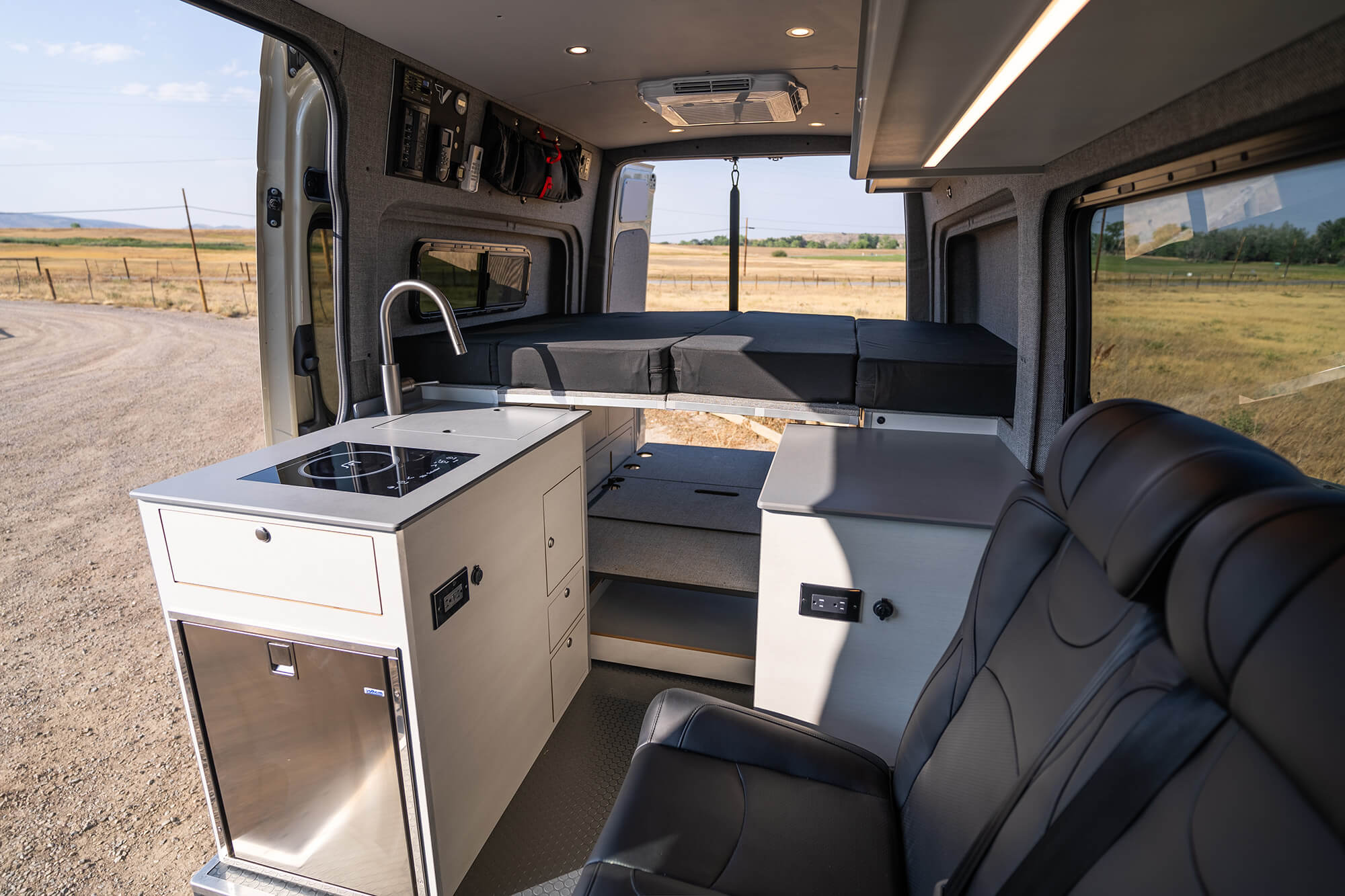 camper van interior with bed kitchen and sofa bed