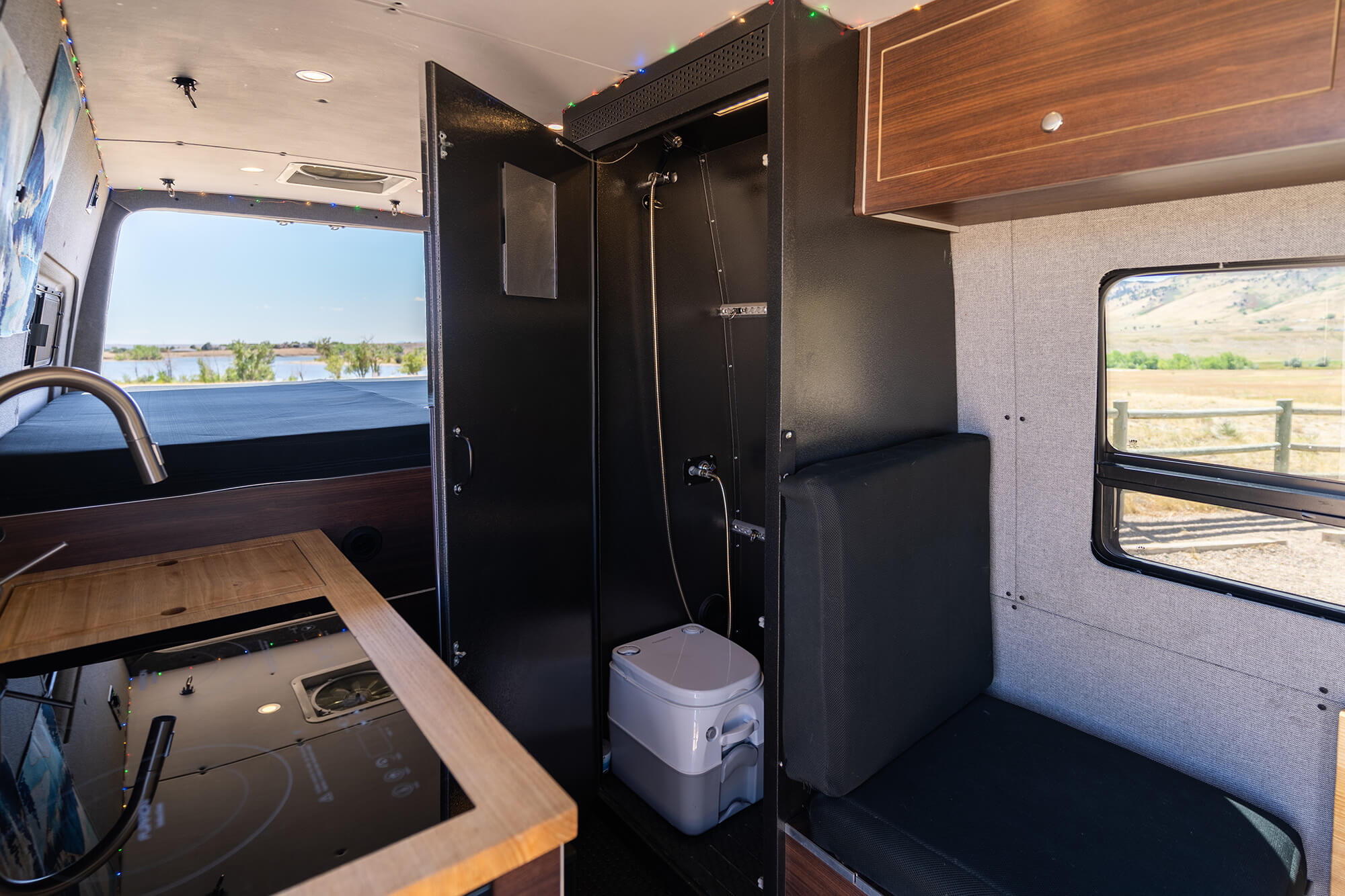 camper van living space with open shower door