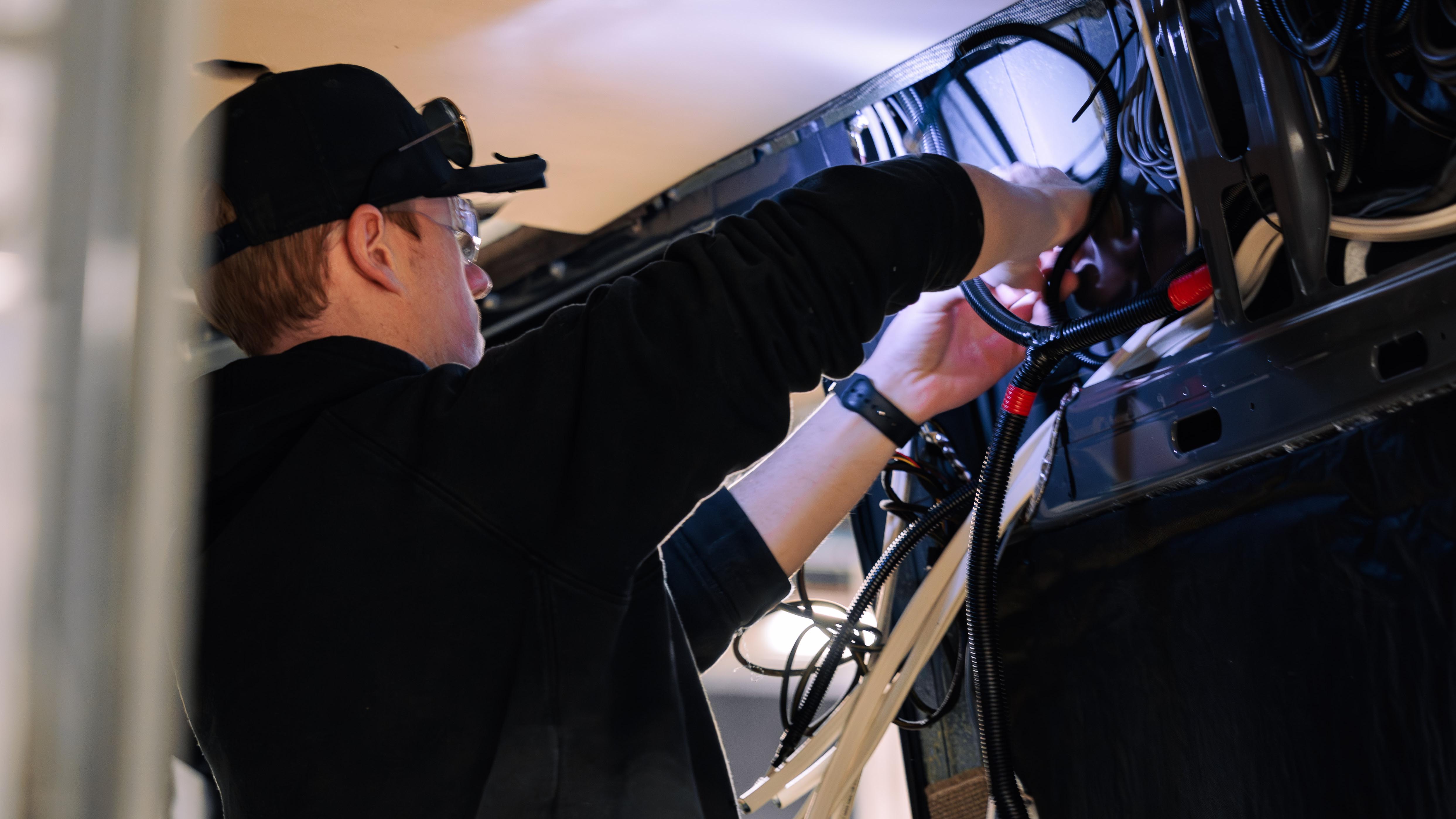 Titan Van Technician installing wiring harnesses.