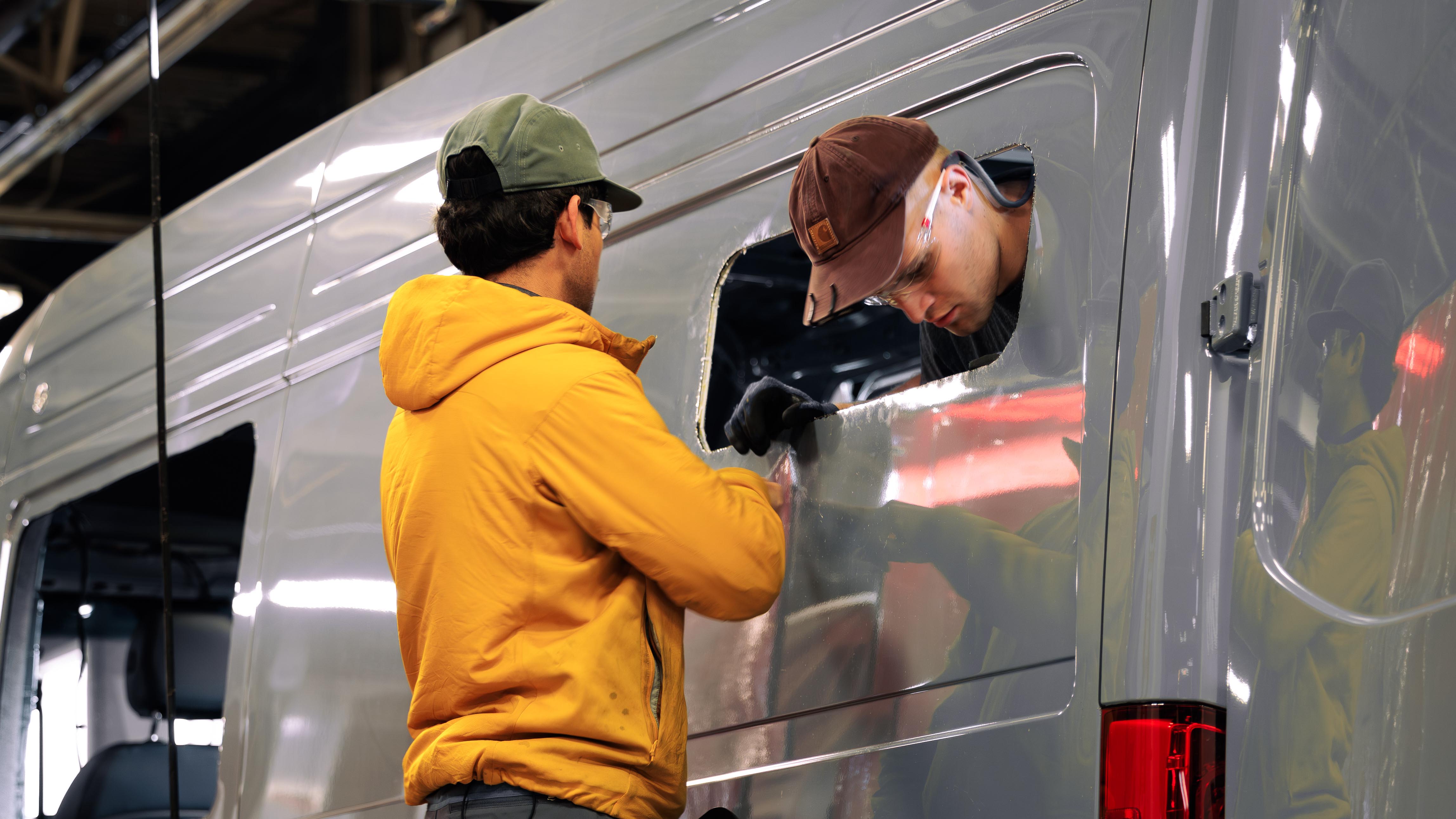 Titan Van Technicians cutting a window