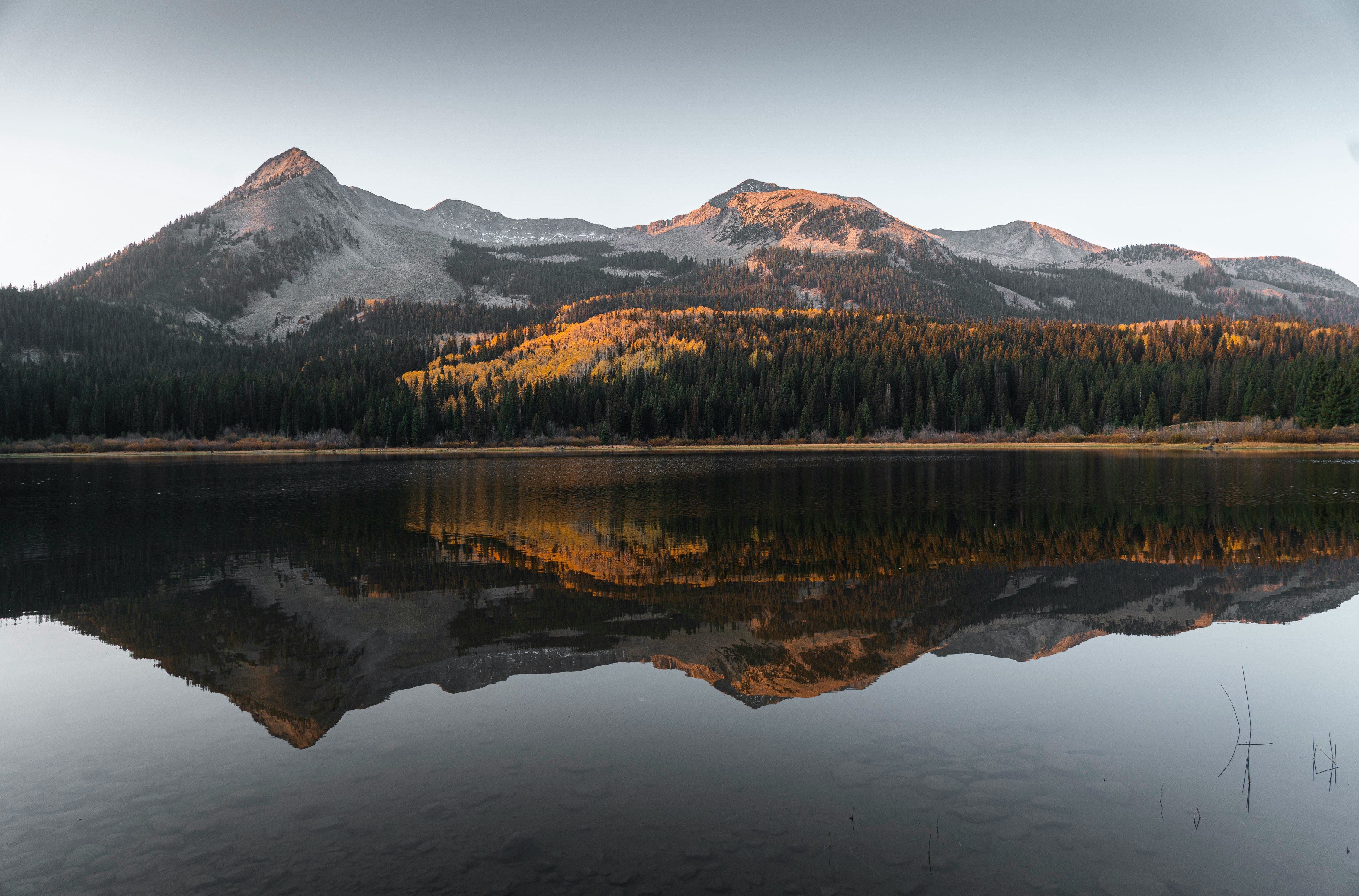 Lake in front of fall leaves and mountains